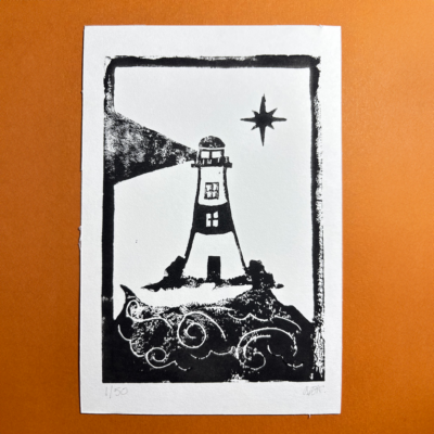 Black ink hand carved lino print featuring a lighhouse, waves, light emitting from the lighthouse and a single star in the sky.